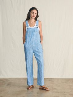 The perfect summer overalls are here. Lightweight linen is dyed with a faded washed indigo - paired with every little detail we could imagine to give these overalls true craftsmanship. Contrasting stitch accents lend a vintage authenticity, while antique brass hardware gives them a timeless appeal. Throw these on over your favorite tank or tee for the ultimate weekend outfit. This style is cut with an oversized fit, so if you're between sizes or want a slimmer fit, we recommend sizing down. Fit: Relaxed fit, Inseam 28". Based on customer reviews, we recommend sizing up Detail: Stripe Linen Overall with antique brass metal buckle closure at the shoulder straps Material: 100% Linen, Vintage Shank, Metal Strap Adjuster & Clasp Model: Alissa is 5’9 wearing size Small Care: Turn inside out Mach Summer Overalls, Tank Jumpsuit, Swim Pants, Antique Brass Hardware, 4th Of July Outfits, Linen Shop, Dress Shirts For Women, Weekend Outfit, Sweater Sale