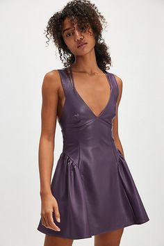 So bold, this vegan leather mini features a flattering fit-and-flare silhouette and deep V-neckline with an open-back and gathered detail at the hips. **Fit:** Fit-and-flare style, A-line hem **Features:** Soft vegan leather fabrication, deep V-neckline, defined seams throughout, gathered hip detail for added dimension, open-back with strappy detailing, self-tying closure, zipper at back **Why We ❤ It:** Perfect with a pair of boots or your favorite flats, this mini is a versatile addition to any wardrobe. | Vera Mini Dress by Free People in Purple, Size: M Free People Dress, Boho Clothing, Leather Mini, Boho Outfits, Fit And Flare, Vegan Leather, Night Out, The Dress, Free People