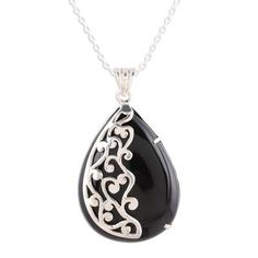 There's something about a polished black onyx gemstone that is almost otherworldly. Indian artisan Babun Dey masterfully designs and crafts this polished, black onyx stone into an incredible pendant necklace, setting it against a highly polished 925 sterling silver cage setting. Half of the stone is set behind the stunning silver, while the other half is laid bare, its infinite black depths hanging prominently around your neck. Onyx Pendant Necklace With Polished Finish, Onyx Necklace With Large Pendant For Gift, Silver Obsidian Pendant Necklace, Black Teardrop Gemstone Necklace, Silver Obsidian Gemstone Necklace, Black Sterling Silver Necklace With Large Pendant, Sterling Silver Necklace With Large Black Pendant, Silver Teardrop Jewelry With Black Enamel, Black Handmade Teardrop Necklace