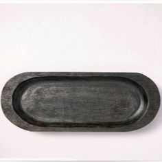 an oval shaped wooden tray on a white background with space for text or image in the center