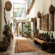 a hallway with plants and potted plants on the wall, along with an area rug