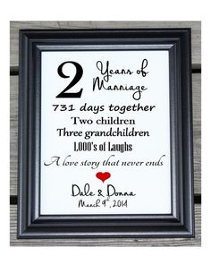 two years of marriage framed in black and white frame with red heart on the bottom