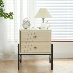 an alarm clock sitting on top of a dresser next to a window