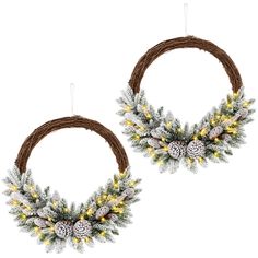 two wreaths decorated with pine cones and lights