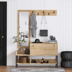 a wooden dresser sitting next to a mirror on top of a hard wood floor in front of a black door