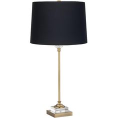 a lamp with a black shade on the base and a gold metal frame around it