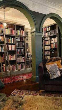 a living room filled with furniture and lots of bookshelves full of books on shelves