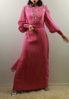 Vintage 70s pink maxi evening dress with voile big sleeves and hight cuffs. Silver geometric decoration. Comes with a extra long voile scarf. Best fit size 10 uk Shoulder to shoulder 37 cm Cheat 42 cm Waist 38,5 cm Hips 50 cm Length 141 cm Model's size 6 UK, h 163 cm Excellent vintage conditions. Shipping of this item takes one week for dry cleaning. I wish the dress is perfect for you! All items are vintage and used. However they are all in good to excellent condition. Any defect is specified. Pink Long Sleeve Evening Dress For Banquet, Long Sleeve Pink Evening Dress For Banquet, Pink Long Sleeve Maxi Dress For Evening, Pink Long Maxi Dress For Eid, Pink Floor-length Party Abaya, Pink Maxi Dress For Evening, Long Pink Dress For Eid, Pink Long Dress For Eid, Long Sleeve Pink Abaya For Wedding