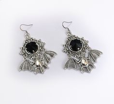 "These large gothic vampire inspired earrings are made with antiqued silver plated bats, filigree settings and stainless steel earring hooks, accented with sparkling glass crystals in JET BLACK. Earrings measure 2 3/4\" tall and are 1 7/8\" wide. Matching necklace is available in our shop. If you would like these in a different stone color, please send us a message." Silver Punk Jewelry For Costume, Silver Punk Costume Jewelry, Punk Style Silver Jewelry For Costumes, Gothic Silver Metal Earrings, Silver Gothic Metal Earrings, Silver Vampire Costume Jewelry, Silver Vampire Style Costume Jewelry, Gothic Nickel-free Halloween Earrings, Gothic Nickel-free Earrings For Halloween