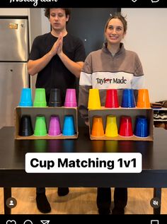 two people standing in front of a table with cups on it and the words cup matching 1v1