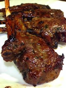 two pieces of meat sitting on top of a white plate