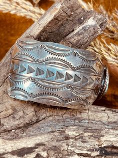 Size: 7 3/8" Gap: 1 1/2" Width: 1 1/4" Weight: 48 grams Hallmark: Sterling This stunning Old Pawn Navajo Sterling Silver Cuff Bracelet features a Turquoise stone measuring 3/4" wide encircled with 2 twisted wire ropes. The stone is a beautiful green with a gorgeous dark brown matrix. The cuff also features traditional Southwest Indian symbols and 13 hand stamped arrowheads on each side of the cuff, 26 total. This cuff just screams the Old Southwest and you will enjoy having in your collection. L Indian Symbols, Rodeo Queen, Southwest Jewelry, Twisted Wire, Sterling Silver Cuff Bracelet, Sterling Silver Cuff, Silver Cuff Bracelet, Natural Turquoise, Native American Jewelry