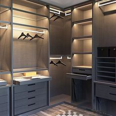 an empty walk in closet with drawers and lights on the ceiling is lit by recessed lighting