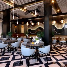 a restaurant with black and white checkered flooring, chandeliers hanging from the ceiling