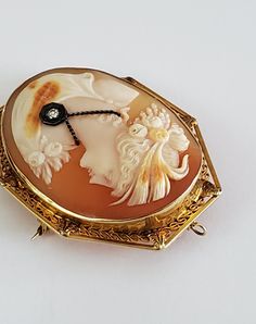 "Antique Large Jeweled Diamond 14k Gold Filigree Cameo Pin Pendant Beautiful large carved shell cameo with genuine diamond pendant set in 14k yellow gold filigree Stunning Fine condition Hallmarked 14k Can be worn as pin or pendant Cameo measures about 2.25\" by 1 9/16\" A rare cameo! Perfect for addition to your collection! Thanks For Shopping!" Elegant Carved Oval Jewelry, Elegant Oval Carved Jewelry, Luxury Cameo Medallion Jewelry, Formal Yellow Gold Cameo Jewelry, Antique Cameo Yellow Gold Jewelry, Antique Yellow Gold Cameo Jewelry, Antique Carved Yellow Gold Jewelry, Luxury Cameo Jewelry, Ornate Cameo Jewelry For Anniversary