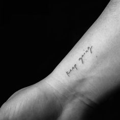 a black and white photo of a person's foot with the word faith written on it