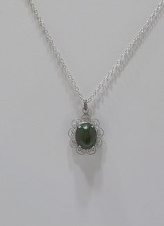 "Vintage olive green jade (new jade) pendant necklace. 15\" silver tone chain with a spring fastener. Sterling filigree frame holds an olive green prong set jade cabochon. Excellent condition." Elegant Nickel-free Jade Necklaces, Silver Jade Cabochon Necklace, Silver Necklace With Jade Cabochon, Silver Jade Necklace With Oval Pendant, Filigree Frame, Funky Necklace, Jade Pendant Necklace, Jade Pendant, Green Jade