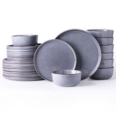 a stack of plates and bowls on a white background