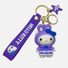 a hello kitty keychain is shown in purple