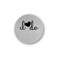 a round metal button with the word i love do on it and a heart in black ink