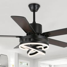 a black ceiling fan with two lights on it in a white living room, next to a mirror