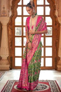 A stylish interpretation of ethnic glamour and contemporary style, this pistachio green silk saree comprises a delightful traditional look.This v-neck and half-sleeve blouse is designed with foil print and printed work.It is set together with silk patola saree in pistachio green color prettified with foil print and printed work.This blouse can be customized up to the maximum size available in inches 44 around the bust. Slight color variation may occur due to photographic reasons. Green Silk Saree, Designer Patola Saree, Green Patola Saree, Silk Patola Saree, Patola Sari, Velvet Suit Design, Patan Patola Saree, Anarkali Suits Bollywood, Cotton Dress Pattern