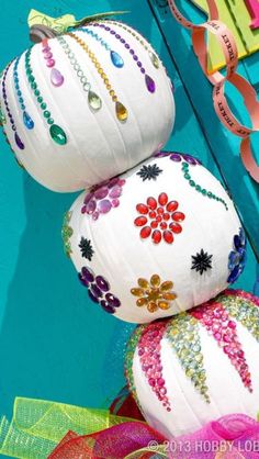 two white paper lanterns are stacked on top of each other with ribbons around the edges