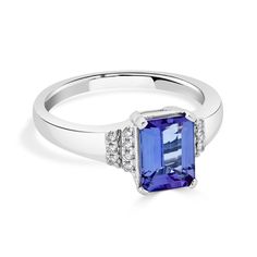 Set with a spectacular emerald cut Tanzanite, this enchanting ring complements your style perfectly. Crafted of lustrous 14K white gold, this arresting ring is bordered by shimmering round cut Diamonds that give it a mesmerizing finish. Product Information SKU ADG50841/7 Metal Type 14K Metal Color White Gold Ring Style Solitaire Primary Stone Gemstone Name Tanzanite Gemstone Species Zoisite No. Of Gemstones 1 Gemstone Shape Emerald Cut Gemstone Weight 1.70 Gemstone Size 8x6 Origin Tanzania Secon Elegant Tanzanite Ring In Radiant Cut, Emerald Cut Tanzanite Diamond Ring, Elegant Tanzanite Ring With Radiant Cut, Classic Tanzanite Emerald Cut Diamond Ring, Elegant Tanzanite Emerald-cut Diamond Ring, Elegant Tanzanite Emerald Cut Diamond Ring, White Gold Diamond Ring With Rectangular Stone, Formal White Gold Diamond Ring With Rectangular Stone, Formal Tanzanite Emerald Cut Rings