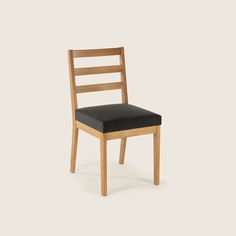 a wooden chair with black seat cushion