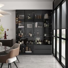 a dining room table and chairs in front of a glass doored cabinet with bottles on it