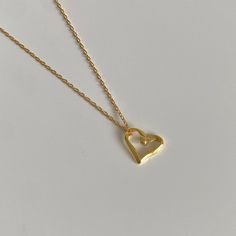 Introducing our Eternal Love Möbius Heart Necklace, a perfect blend of a modern design with a timeless symbol of love. This heart necklace is meticulously crafted from 925 sterling silver, bathed in a layer of radiant 18k gold, resulting in an exquisite gold necklace. The pendant features a hollow heart shape, designed like a Möbius strip, symbolizing eternal love, turning it into both a pendant necklace and a charm necklace in one. The necklace comes with an adjustable clasp, allowing it to be Möbius Strip, Elegant Heart-shaped Brass Necklace, Personalized Heart-shaped Brass Necklaces, Bronze Heart-shaped Brass Necklace, Mobius Strip, Heart-shaped 14k Gold Charm Necklace For Valentine's Day, Dainty Gold Chain, Valentine's Day Gold-tone Heart Pendant Necklace, Chain Heart