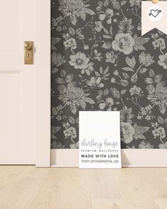 an open door with a sign on it in front of a wallpapered room