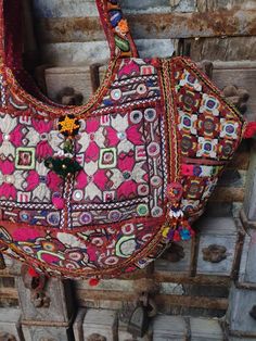 About bag  Indo-gypsy fusion, everyday use hand bag made from Banjara fabrics sourced from Vintage tribal costumes of regions of Rajastan and Gujarat. These are embellished with light catching coins, and intricate bead work tassels. Size - length 15 inches/ width 22 inches Company details:  Company name: Houseoftextile  Contact number: +919784447473  Email id: houseoftextile77@gmail.com  Shipping & custom : Delivery through one of the finest service providers : Skyway, Fedex, UPS  And DHL. Any l Traditional Handmade Multicolor Embroidered Hobo Bag, Traditional Handmade Multicolor Embroidery Hobo Bag, Traditional Multicolor Embroidered Bag For Festivals, Traditional Bags With Mirror Work For Festivals, Traditional Multicolor Embroidered Festival Bag, Bohemian Embroidered Shoulder Bag For Navratri, Traditional Handwork Bags For Festivals, Traditional Festival Bags With Handwork, Handwork Multicolor Embroidery Bags For Navratri