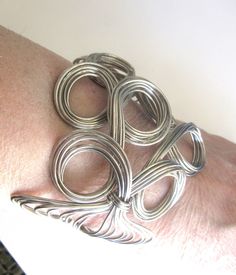 Unique hand crafted ornate open wire work cuff bangle / statement Bracelet in a loop and swirl design.  High at the front 3" inches, sides are 2" inches.  The measurement all the way around is 7.5 inches and the space between the two open ends is 1.5 inches.  Excellent condition. Arm Bangles, Black Bracelets, Statement Bracelet, Swirl Design, Wire Work, Cuff Bangles, Star Pendant, Handmade Artisan, Silver Glitter