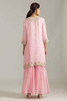 Pink kurta with silver floral embroidered motifs highlighted by cutdana and scalloped borders. Comes with sharara and dupatta.
Components: 3
Pattern: Embroidered
Type Of Work: Sequin,Cutdana
Neckline: Notched
Sleeve Type: Three quarter
Fabric: Georgette,Net
Color: Pink
Other Details: 
Cut-out borders
Gota detail
Attached lining
Closure: Sharara: Elasticated waistband
Occasion: Mehendi and Haldi,Sangeet - Aza Fashions Cutdana Sharara For Eid Reception, Diwali Reception Sharara With Dori Work, Reception Sharara With Dori Work In Chinon, Semi-stitched Sharara With Gota Work For Reception, Chinon Sharara With Dori Work For Reception, Wedding Sharara With Dori Work In Georgette, Wedding Georgette Sharara With Dori Work, Georgette Sharara With Gota Work For Reception, Reception Georgette Sharara With Gota Work