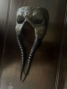 This mask was cast in polyurethane resin and was hand painted in ink, watercolors, and acrylics. The Hunter's Mask hangs on a leather cord. The mask is 5.5" wide and 12" long. Adjustable Fantasy Masks And Prosthetics For Events, Artistic Halloween Masks For Fantasy Events, Artistic Masks For Art Events, Hand Painted Black Mask For Masquerade, Hand Painted Black Masquerade Mask, Handmade Adjustable Masks For Masquerade, Handmade Unique Masks And Prosthetics For Masquerade, Artistic Masks And Prosthetics For Themed Events, Artistic Handmade Black Masks