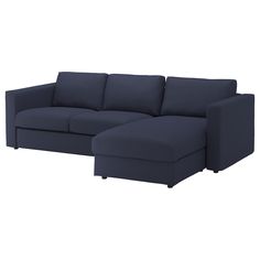 a blue sectional couch sitting on top of a white floor