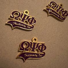 three purple and gold metal name tags on a white surface with the word hope written in cursive writing