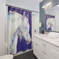 a white horse shower curtain in a blue and white bathroom with black tile flooring