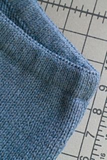 a blue sweater is next to a ruler