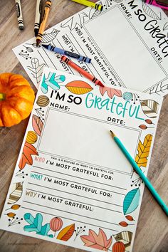 some writing paper and pencils on a table with pumpkins, markers and crayons