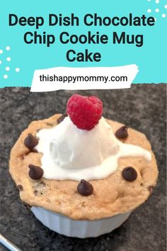 a chocolate chip cookie mug cake topped with whipped cream and raspberries on top