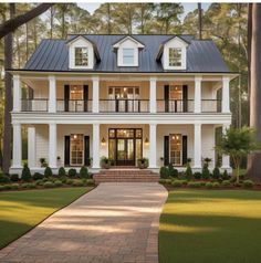 a large white house with black shutters on the front and second story, surrounded by trees