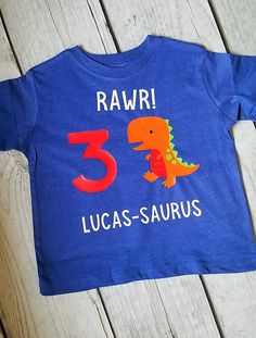 Perfect tee to celebrate your little mans birthday! Made with a white cotton bodysuit or tee shirt and heat transferred vinyl. Number on the shirt can be changed. Just leave a note at checkout. PLEASE LEAVE NAME FOR PERSONALIZATION IN THE NOTES AT CHECKOUT. Sizes Available: Bodysuits available upon request. Message me for color choices. Regular T Shirt Style 12M 18M 2T 3T 4T 5T XS Youth (4-6) S Youth (6-8) M Youth (8-10) L Youth (12-16) Washing Instructions: Wash with like colors. Cold or Warm w Birthday Dinosaur Print Short Sleeve T-shirt, Dinosaur Print Short Sleeve T-shirt For Birthday, Birthday T-shirt With Dinosaur Print, White T-shirt With Dinosaur Print For Birthday, Birthday Dinosaur Print Short Sleeve Top, Dinosaur Print Short Sleeve Top For Birthday, First Birthday T-shirt With Dinosaur Print, Dinosaur Print Short Sleeve T-shirt For First Birthday, Summer Dinosaur Print Top For Birthday