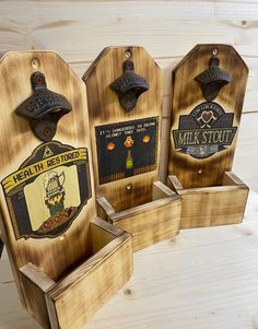 three wooden bottle openers sitting on top of each other