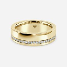 a yellow gold wedding ring with channeled diamonds on the side and a plain band