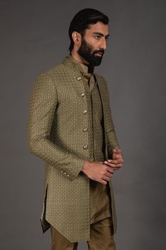 Olive green front open achkan with embroidered detail and full sleeves. Paired with shirt style kurta and lounge pant.
Component: 3
Pattern: Embroidered
Neckline: Mandarin
Sleeve Type: Full Sleeves
Fabric: Chanderi Silk, Cotton Silk
Color: Green
Other Details: 
Silk thread work
Front buttons
Printed lining
Note: Waistcoat worn by the model is not for sale
Occasion: Sangeet - Aza Fashions Traditional Zari Work Sets For Semi-formal Occasions, Pista Green Dabka Work Sets For Formal Occasions, Formal Pista Green Sets With Chikankari Embroidery, Formal Pista Green Set With Zari Work, Green Long Sleeve Suit For Eid, Unstitched Pista Green Formal Sets, Pista Green Designer Sets With Naqshi, Pista Green Formal Sets For Eid, Traditional Long Sleeve Semi-formal Sets