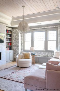 a living room filled with furniture and a fire place in front of a large window