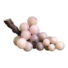 some white and pink marble balls on a branch