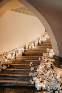 candles are lit on the steps leading up to an aisle